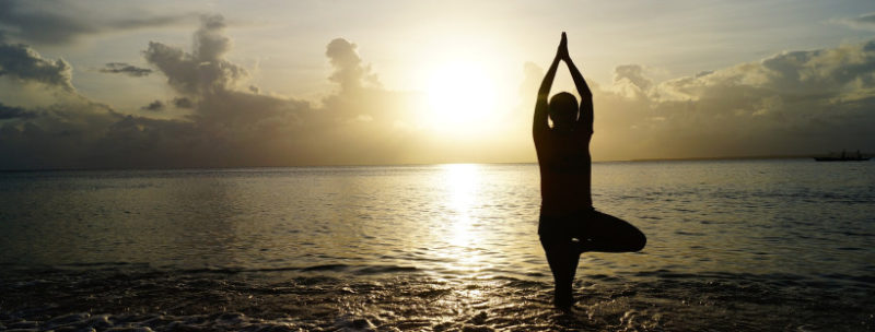 Yoga Pose by Water at sunset